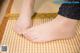 A close up of a person's feet on a mat.