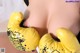 A woman wearing yellow boxing gloves with graffiti on it.